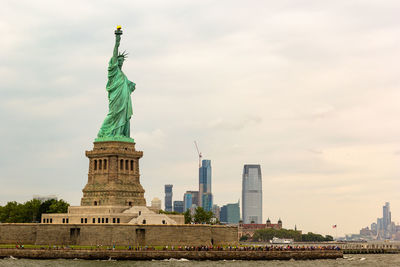 The statue of liberty with visitors on liberty island. the view of the gorgeous statue of liberty.
