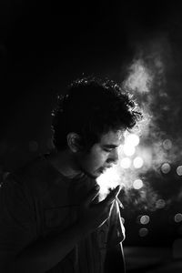 Portrait of young man looking away outdoors