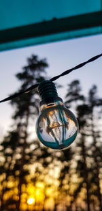 Low angle view of light bulb against sky