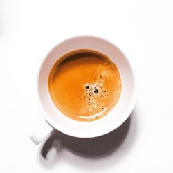 High angle view of coffee cup over white background