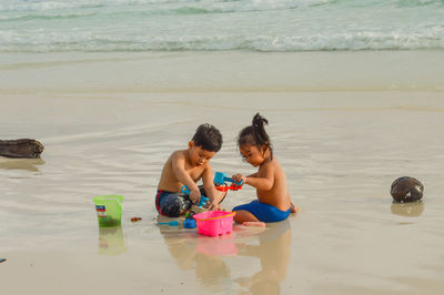 Children playing with toy on beach