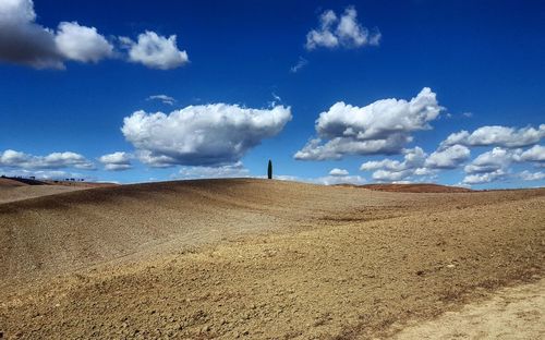 Panoramic view of landscape against blue sky