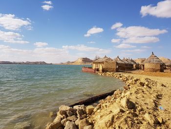 Scenic view of sea against buildings