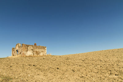 Low angle view of castle against clear blue sky