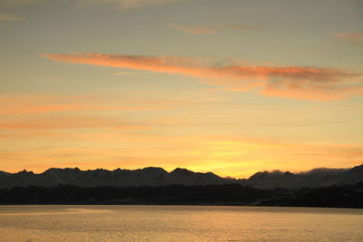 Scenic view of silhouette mountains against sky during sunset