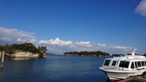 Boats in sea against blue sky