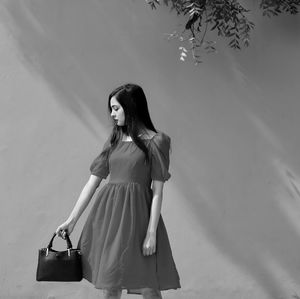 Rear view of woman standing against sky