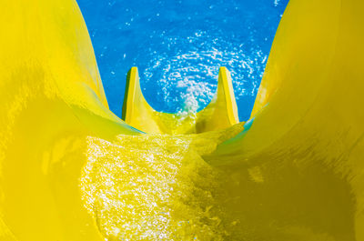 High angle view of yellow slide at water park