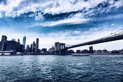 Brooklyn bridge over east river with manhattan skyline