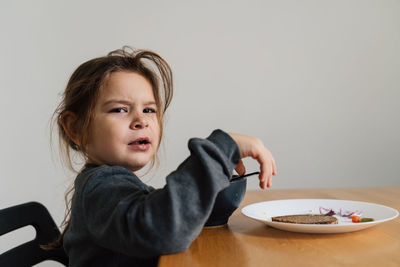 Portrait of cute girl eating breakfast