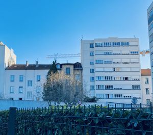 Buildings against clear blue sky