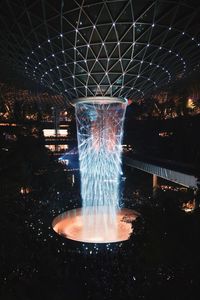 Digital composite image of illuminated fountain at night