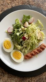 Breakfast. salad with cabbage and radishes and grilled sausage