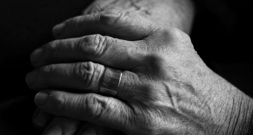 Close-up of hands against black background