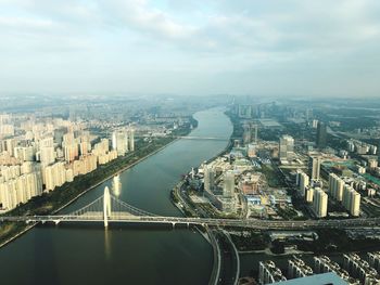 High angle view of bridge over river amidst buildings in city