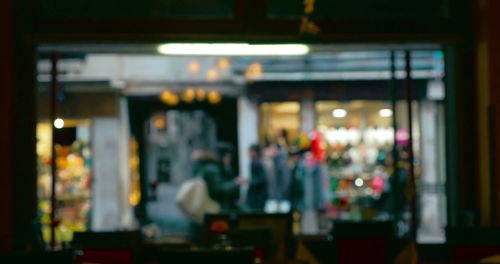 Defocused image of illuminated restaurant at night