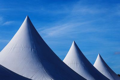 Low angle view of modern building against blue sky