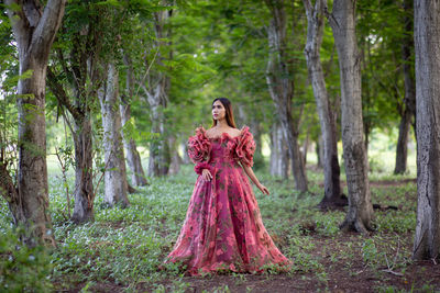 Woman standing in forest