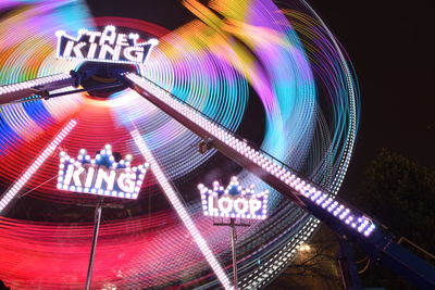 Low angle view of illuminated lights against sky at night