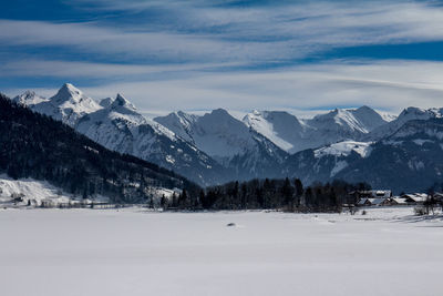 Snow covered landscape against the sky