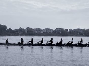 People enjoying in river against sky