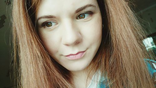 Close-up portrait of smiling young woman