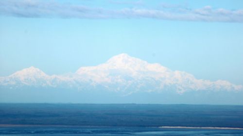 Scenic view of sea and mountain against sky
