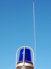 Low angle view of vapor trail against clear blue sky