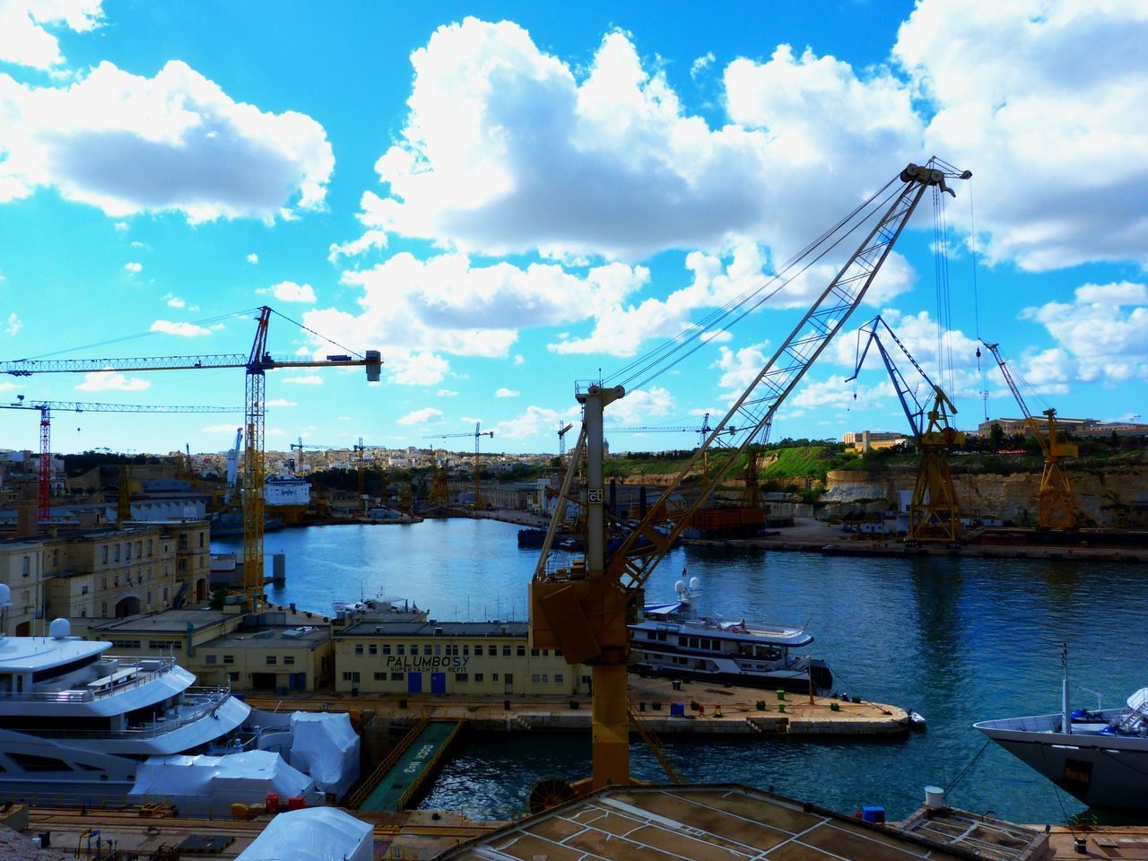 SAILBOATS MOORED AT HARBOR