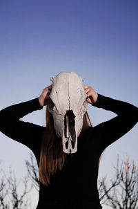 Low angle view of animal skull against clear sky