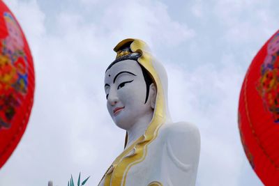 Low angle view of buddha statue against the sky