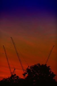 Low angle view of silhouette trees against sky at sunset