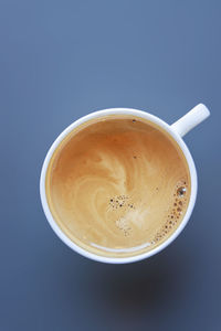 Directly above shot of coffee on table against blue background