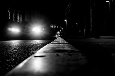 Man on illuminated car at night