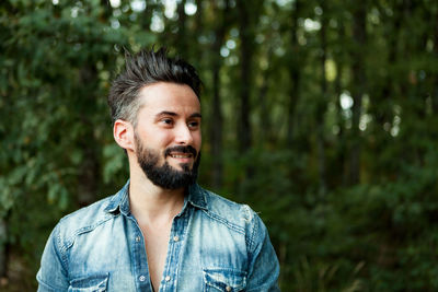 Portrait of smiling young man in forest