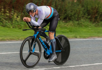 Man riding bicycle on road