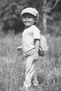 Portrait of boy standing on field