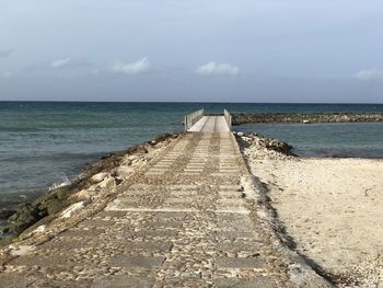 Pier over sea against sky