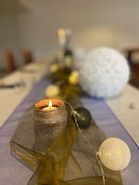 Close-up of lit candles on banquet table
