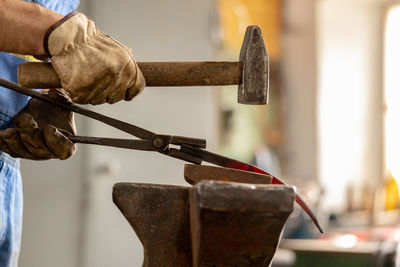 Close up view of heated metal and anvil. the blacksmith in the production process of metal products 