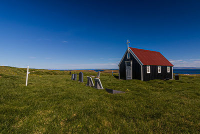 Built structure on field against blue sky