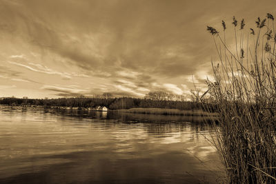 Scenic view of lake against cloudy sky