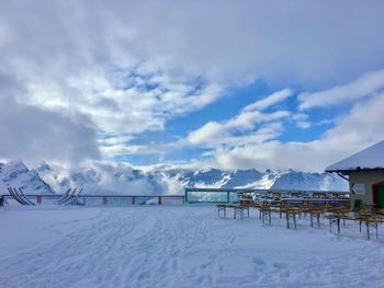 Snow covered land against sky