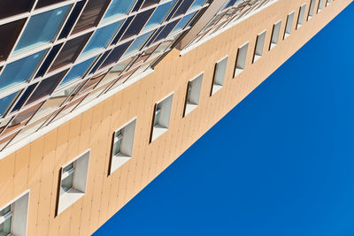 Low angle view of building against clear blue sky