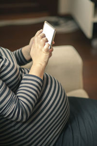 Midsection of woman using mobile phone