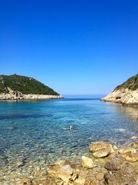 Scenic view of sea against clear blue sky