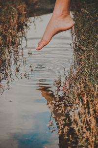 Reflection of person in lake