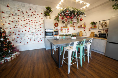 Empty chairs and table against wall at home