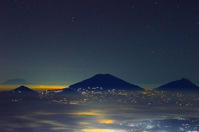 Scenic view of illuminated mountain against sky at night