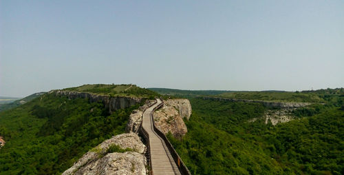 Scenic view of mountain road against clear sky